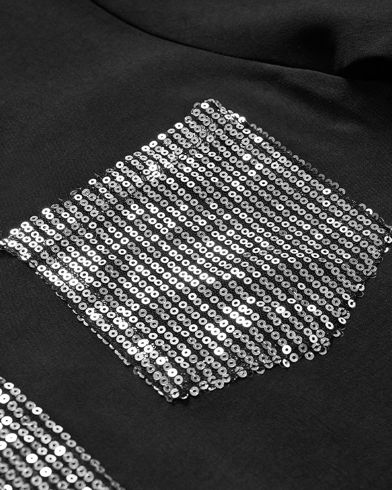 Avslappnad topp med paljettknappar med panel